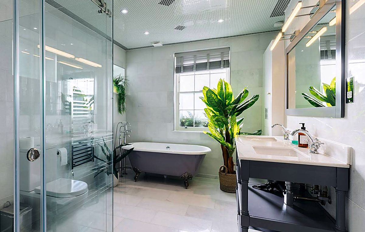 Luxury bathroom installation with a freestanding roll-top bath, walk-in shower and double vanity
